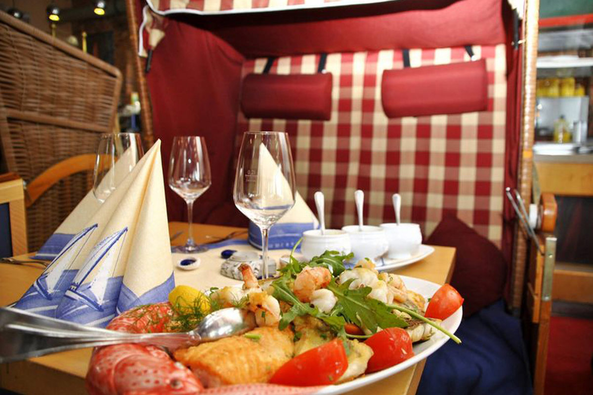 Gedeckter Tisch mit Fischspezialitäten im Restaurant Bootshaus Binz.